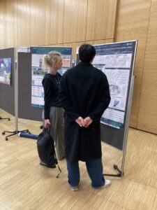 Kaire Toming with poster